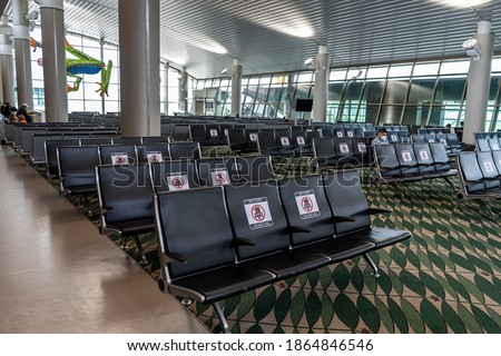 Waiting room of an airport in the Coronavirus times with sitting restriction