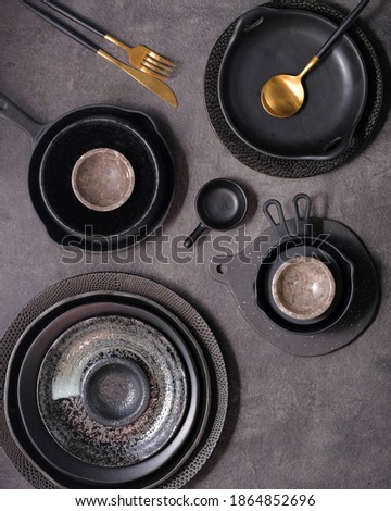 Ceramic tableware on black background.