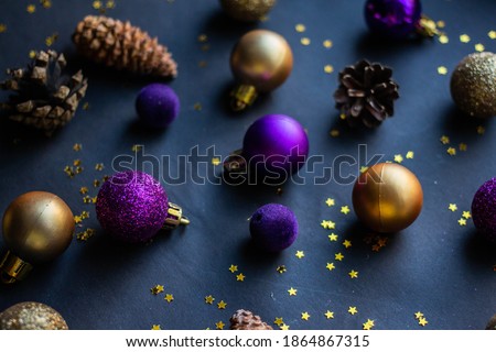 background with cones, Christmas toys, stars on a dark table