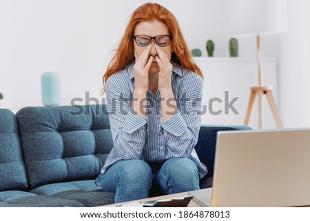 Stressed woman working from home and suffering headache