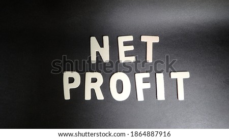 Net Profit letters on black background. Concept for, art, calendar and new year.