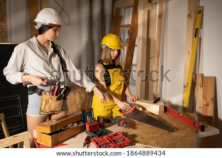 Young adult teens dressed with builder work clothes and personal protective equipment.