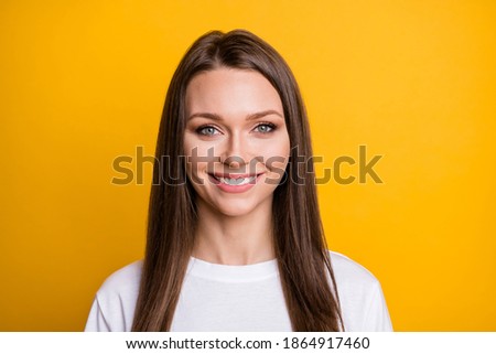 Photo portrait of smiling woman isolated on vivid yellow colored background