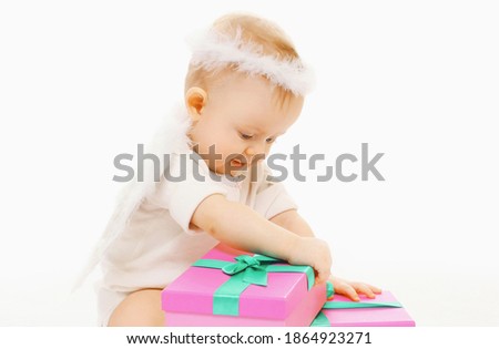 Portrait of cute baby playing with toys over a white background