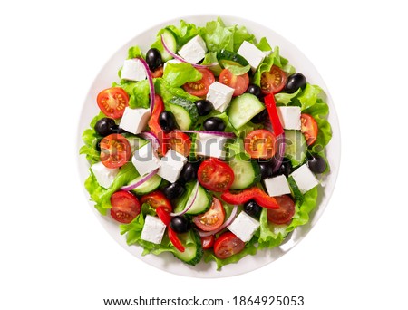 Plate of fresh salad with vegetables, feta cheese and olives isolated on white background. Top view