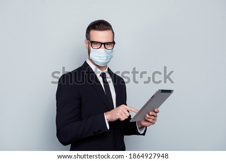 Photo of handsome smart intelligent expert wear suit fsce mask holding digital gadget isolated gray color background