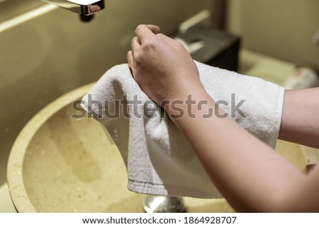 Asian women are wiping their hands after washing their hands. Wash your hands regularly to prevent the coronavirus.