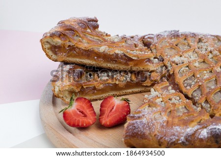 Strawberry pie on a light background with fresh strawberries