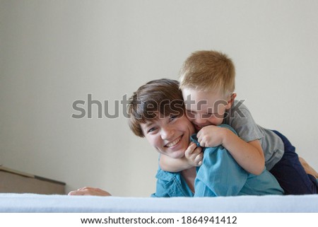 mother's day. mother's love. A happy mom with son in blue cloth embrace. Isolated on a white background. copy space. Game with child