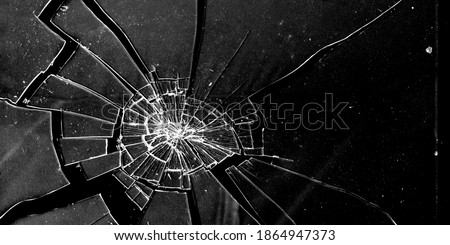 Сracked glass close-up on dark background. Texture of broken glass. Isolated realistic cracked glass effect. Template for design. Black and white illustration. 3D rendering  Royalty-Free Stock Photo #1864947373
