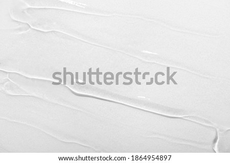 Transparent gel cream, serum, essential oil with bubbles on white background. Texture of beauty cosmetic product close-up. Moisturizing nourishing hyaluronic acid, cleansing skincare lotion Royalty-Free Stock Photo #1864954897