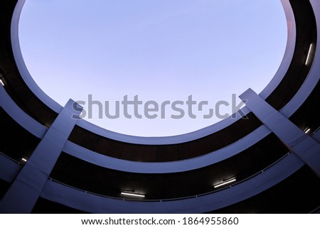 multi-level spiral car parking with blue sky.