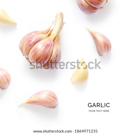 Creative layout made of garlic on the white background. Flat lay. Food concept. Royalty-Free Stock Photo #1864971235