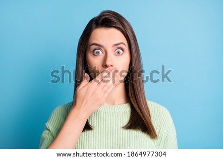 Photo of lovely young lady arm close cover mouth afraid face wear green sweater isolated blue color background