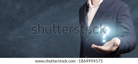 Businessman holding hand question marks in his hand. Businessman showing Question mark. man holds a glowing question mark in his hand. banner, blue background