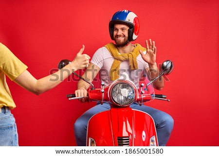hitchhiking concept. cropped woman hitching man on motorcycle, affable friendly man say hello, glad to help, isolated red background