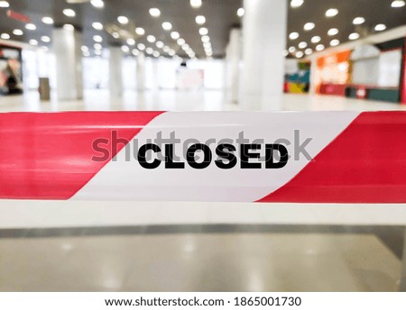 Text on the red ribbon at the store during the coronavirus CLOSED