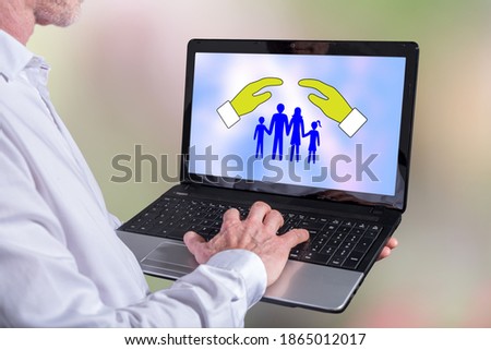 Man using a laptop with family protection concept on the screen