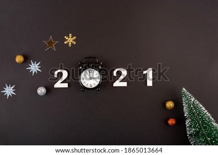 Wodden 2021 Creativity and inspiration ideas concepts with little clock on black color background. Business solution. New years content