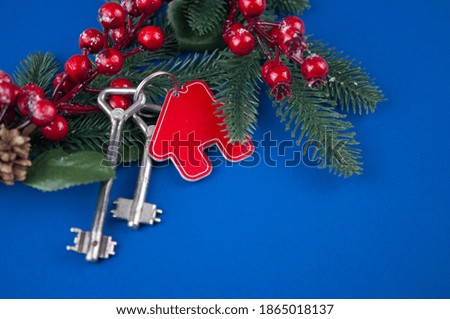 Beautiful Christmas background: decorative house and key to the lock. Concept of finance and housing loans. Top view. Real estate.