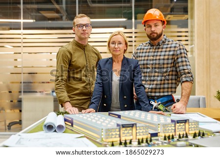 portrait of successful team of architect, investor and director posing at camera, they gathered to plan construction project, search new ideas. partnership and cooperation Royalty-Free Stock Photo #1865029273