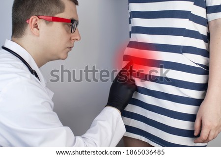 A woman suffers from pain in the appendix. Acute appendicitis, Crohn's disease, or inflammatory bowel disease. Surgeon examination and preparation for laparoscopic appendectomy Royalty-Free Stock Photo #1865036485