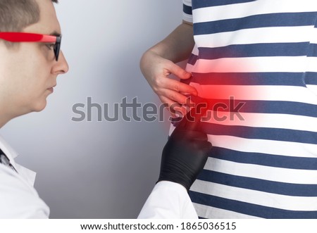 A woman suffers from pain in the appendix. Acute appendicitis, Crohn's disease, or inflammatory bowel disease. Surgeon examination and preparation for laparoscopic appendectomy Royalty-Free Stock Photo #1865036515
