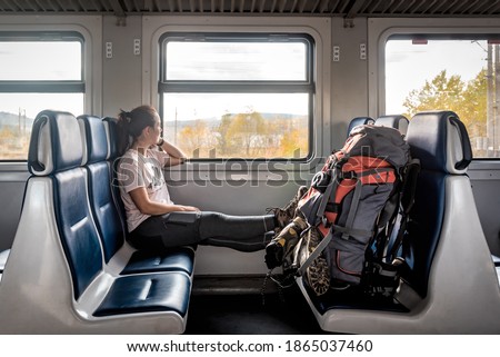 tourist woman with a backpack sitting in the train