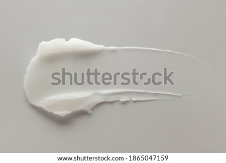 Cosmetic white creamy mask balm gel gray textured background Royalty-Free Stock Photo #1865047159