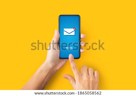 Online correspondence concept. Top view of young lady pressing READ button on cellphone with incoming email, orange background. Unrecognizable woman getting electronic letter Royalty-Free Stock Photo #1865058562