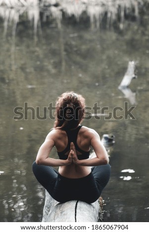 Girl go in for sports in the forest. In the lotus position. Exercises, gymnastics, relaxation. Healthy lifestyle.