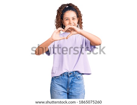 Beautiful kid girl with curly hair wearing casual clothes smiling in love doing heart symbol shape with hands. romantic concept. 