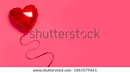 Love, Valentine's Day concept. Red balloon in the shape of heart on pink background top view flat lay copy space. Holiday Object, Birthday, Wedding. Party decoration. Greeting card with heart 