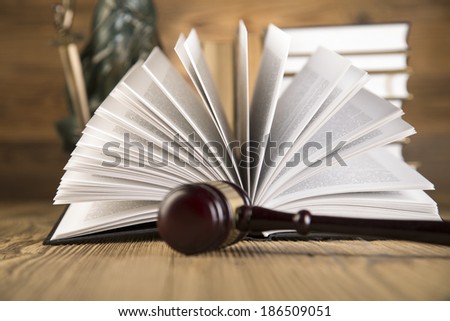 Lady of justice, Wooden & gold gavel and books on wooden table on brown wooden background