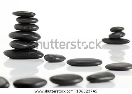 Wet smooth polished hot massage black stones white background