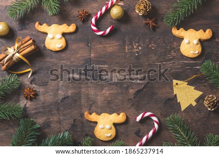 christmas background. christmas composition with fir branches, gifts, sweets, cookies, cinnamon on a dark wood background