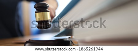 Wooden gavel for judge on table next to folder with documents. Justice and law enforcement concept Royalty-Free Stock Photo #1865261944