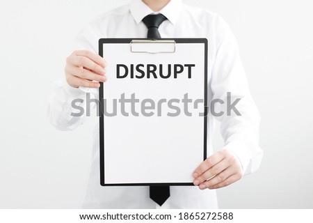 Businessman holding white sheet on chalkboard with Disruptive inscription on isolated gray background