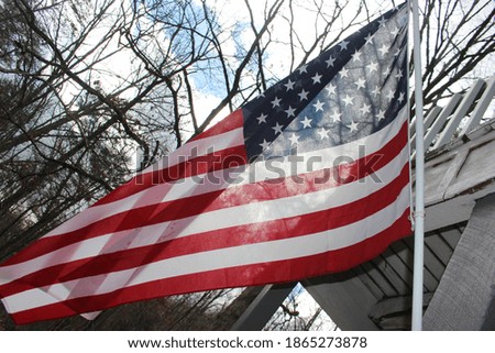 flying American flag on house