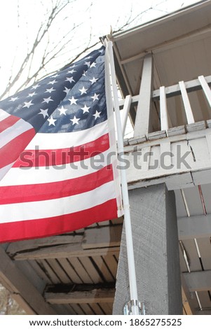 flag flying and hanging off the porch