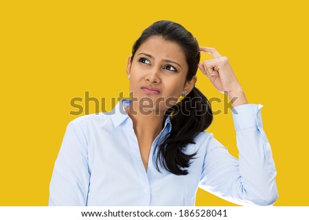 Closeup portrait, beautiful, pretty young woman thinking daydreaming trying to remember something, scratching head looking upwards, isolated yellow  background. Human facial expressions signs symbols