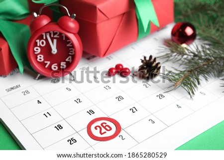 Composition with calendar and gifts on green background, closeup. Boxing day concept