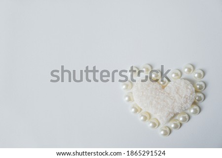 Heart and pearls. Love Concept. Happy Valentines Day background. Selective focus on a heart. Bokeh effect.  