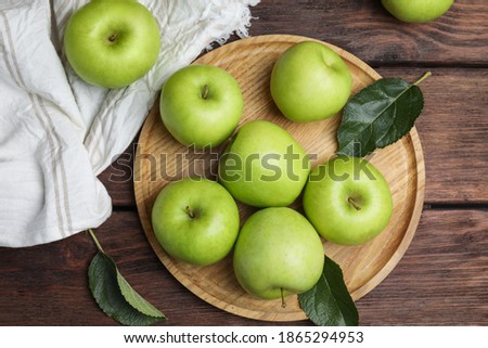 Fresh ripe green apples on wooden table, flat lay Royalty-Free Stock Photo #1865294953
