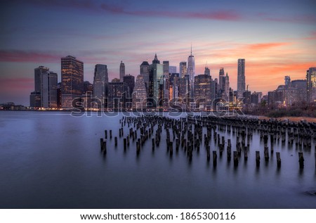 Big City skyline at sunrise from Brooklyn while the lights of the buildings go out