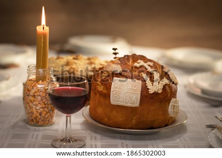 Veneration of the family`s patron saint. Homemade Slava cake, wheat and glass of red wine Royalty-Free Stock Photo #1865302003