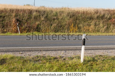 White reflector post at a country road