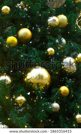golden decorations toy balls hang on Christmas tree