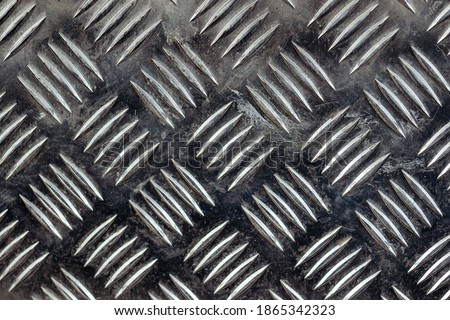 Diamond plate texture, background iron sheets with grooved notches, exterior floor covering in metal with engraved print, pattern style of steel floor for background,
