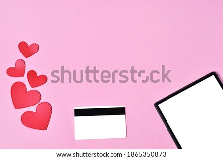 Layout, top view for valentine's day online shopping and sales. tablet, hearts, credit card. blank phone screen and credit card